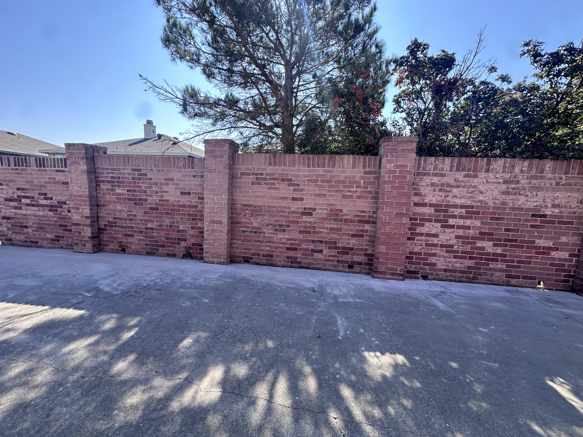 Failing brick fence and retaining wall in Fort Worth needing repair – structural masonry restoration services in Tarrant County