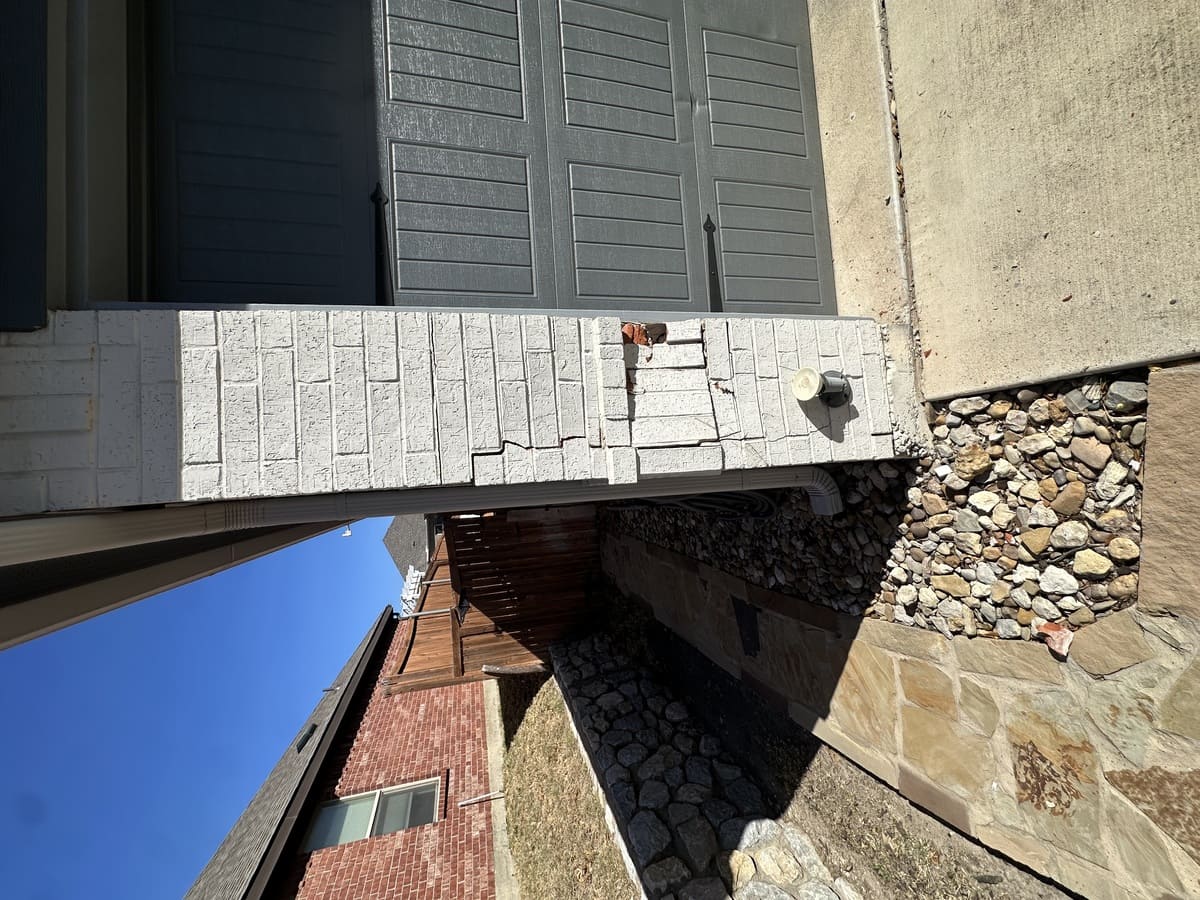 Efflorescence and water staining on Fort Worth brick wall — white salt deposits indicating active moisture migration through masonry