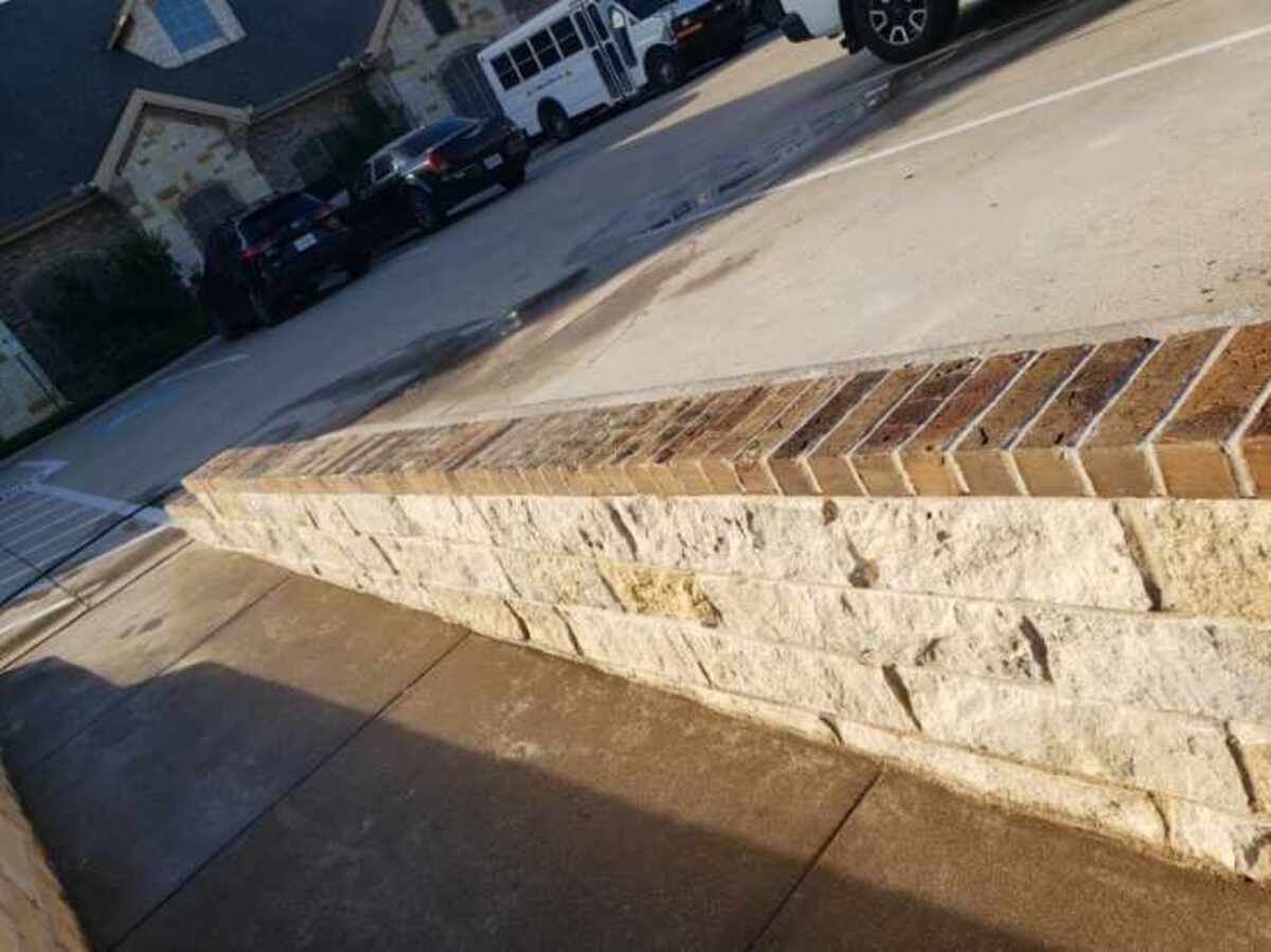 Small knee retaining wall built for children's daycare in Fort Worth, Texas – safe commercial masonry construction and landscaping