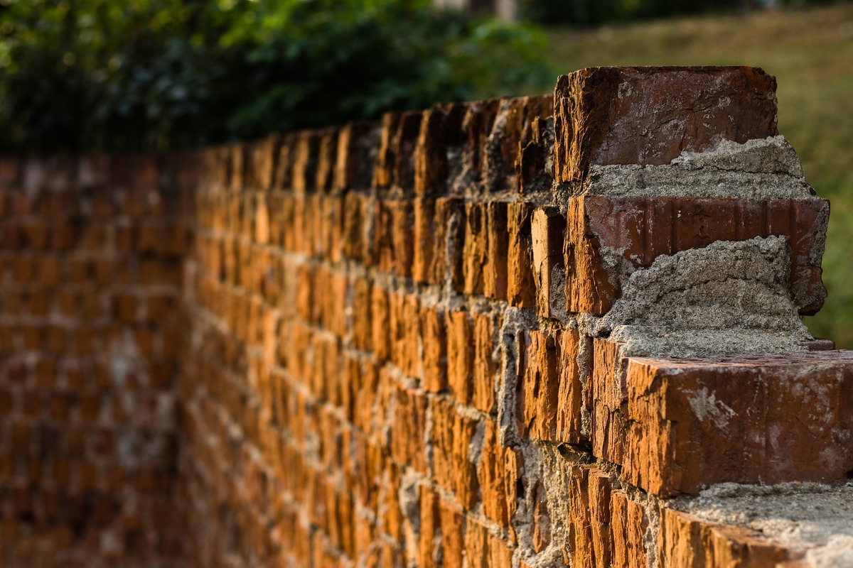 Historic brick retaining wall restoration in Fort Worth – preservation masonry repair maintaining architectural heritage in North Texas
