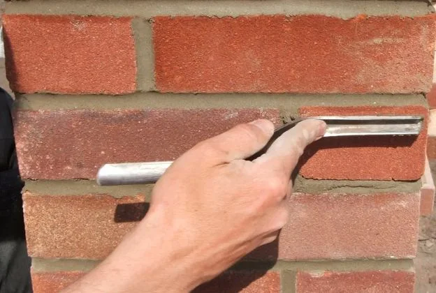 Precision mortar joint matching on brick mailbox in Fort Worth — seamless tuckpointing with color-matched mortar